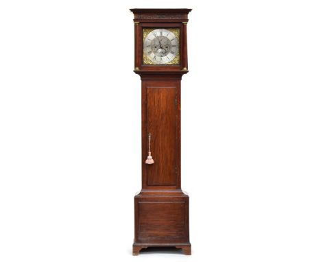 A late 18th century oak longcase clock, blind fretwork over the 12" dial flanked by brass capped columns, with silvered brass