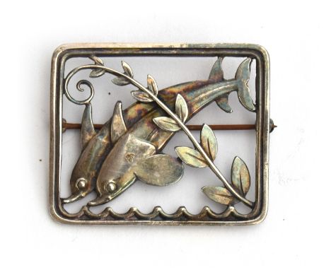 A c.1940s Georg Jensen sterling silver brooch featuring two dolphins designed by Arno Malinowski, marked 'GEORG JENSEN STERLI