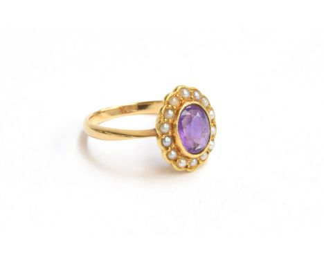 An 18ct gold seed pearl and amethyst ring, gross weight 3.8g, size M 