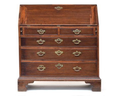 A George III oak bureau, fall front with fitted interior, two short with three graduating drawers, bracket feet, 100cm high 