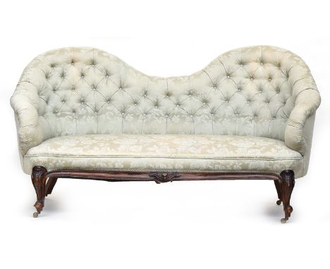 A 19th century French walnut button back bucket end sofa, on acanthus carved cabriole legs on casters, approximately 180cm wi