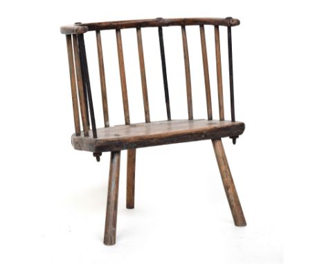 An 18th century provincial 'cut down' comb back chair, possibly Welsh, the back having four iron supports, on three splayed l