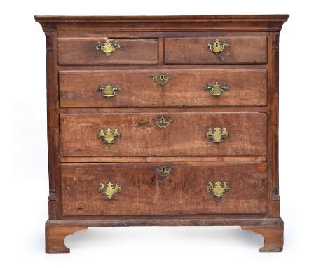 A basically 18th oak chest of two short over three graduating drawers, the drawers flanked by quarter columns, on bracket fee