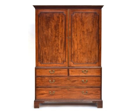 A George III mahogany linen press, the cornice above a pair of doors with outline mouldings, enclosing four slides, the base 