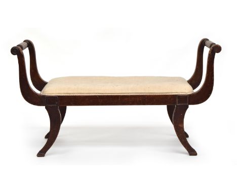 A large Regency upholstered duet stool, the reeded arms on swept supports, 117cm wide 