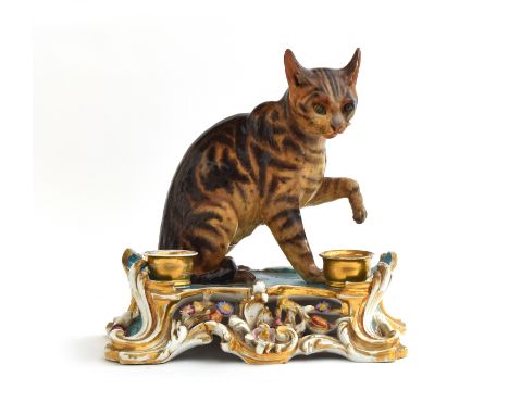 A mid 19th century Jacob Petit (1797-1868) porcelain inkstand with original removable inkwell and sander, depicting a seated 