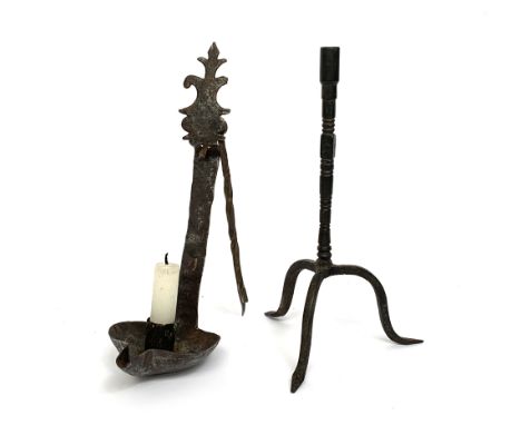 A wrought iron hanging candle holder; together with an 18th century steel tripod legged socket candlestick, 24cm high