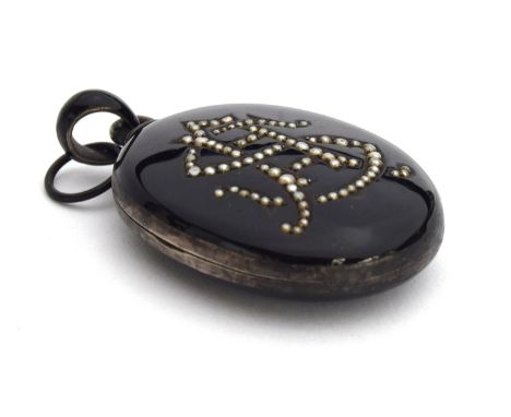 Victorian silver and black enamel mourning locket with the initials 'SA' formed in seed pearls, 5cmHProvenance: From the esta