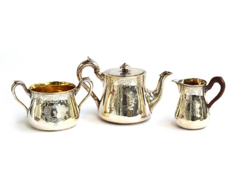 A Victorian silver three piece teaset by John Samuel Hunt, London 1864, with engraved decoration, the milk jug and sugar bowl