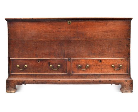 A Georgian oak mule chest, hinged lid with moulded edge, two cockbeaded drawers, on bracket feet