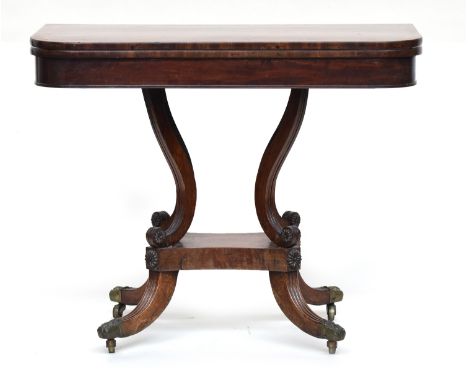 A Georgian mahogany card table, swivel top, with brass acanthus capped feet, crossbanded top, scrolling swept supports with r