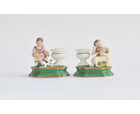 A pair of 19th century Staffordshire Dudson inkwells, in the form of young girls beside an urn, one with a lamb, the other wi