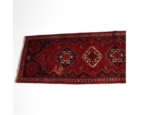 A Persian design red and blue ground geometric design rug, width 115cm