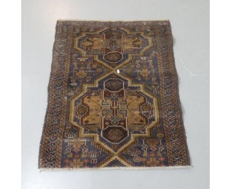 A blue-ground Persian prayer rug. Length 107cm, width 87cm.Appears to have been reduced in length.