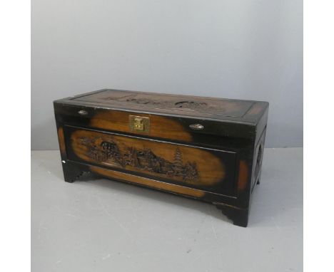 A vintage stained camphor wood Chinese design blanket box with carved decoration. Width 122cm, Height 55cm, Depth 54cm.