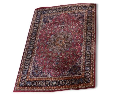 A Persian design red and blue ground floral pattern rug, 335cm x 240cm