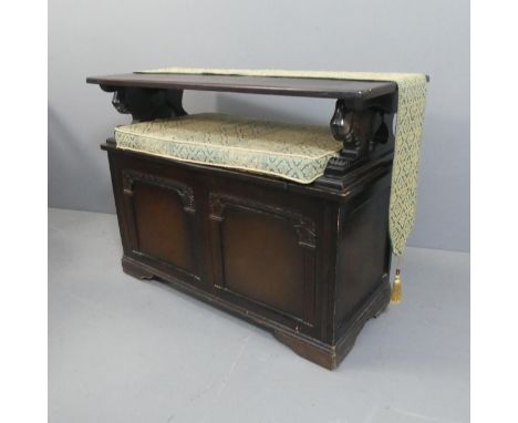 An early 20th century panelled oak Monk's bench with lifting seat. Dimensions (as bench) - width 101cm, height 99cm, depth 43