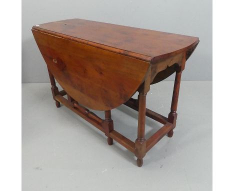 An antique yew-wood gate-leg drop-leaf table. Width 122cm, height 75cm, depth 47cm.Natural knot-holes to top and to leaf.