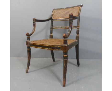 A Georgian Irish ebonised and gilt painted desk chair, with cane panelled back and seat on ash frame.Overall width 56cm, heig
