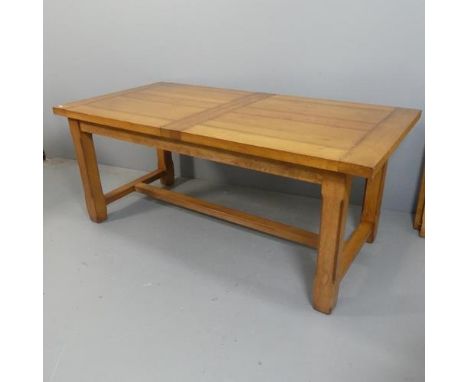 A contemporary oak draw-leaf dining table, with two spare leaves and H-shaped stretcher. Length 181cm (extending to 261cm), h