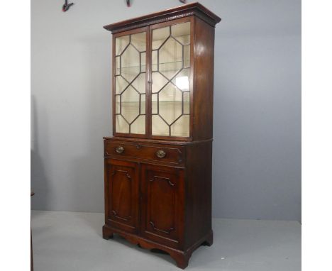 A Georgian mahogany two-section secretaire bookcase, with two lattice glazed doors, single secretaire drawer revealing a fitt