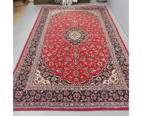 A red-ground Persian carpet. Length 297cm, width 188cm.