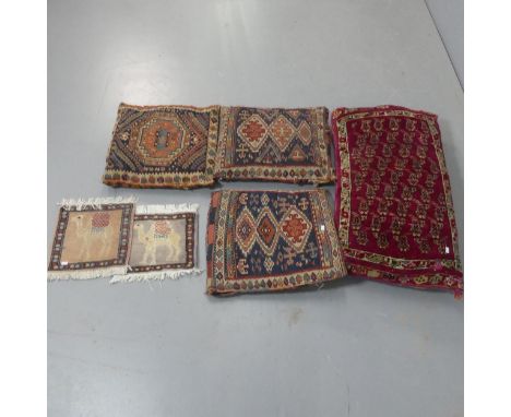 Three Kilim upholstered cushions, another cushion and two miniature mats with camel design. Largest, width 85cm, height 45cm.