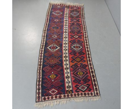 A red and blue-ground Persian runner. Length 208cm, width 79cm.