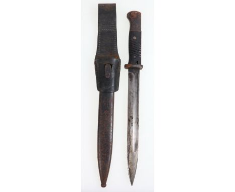 German S84/98 bayonet, the ricasso stamped Berg & Co., blade back stamped 40, bakelite grips, the scabbard with matching numb
