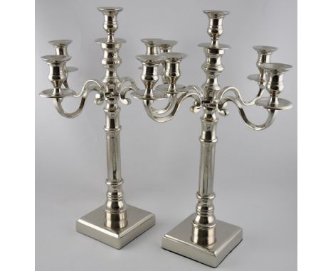 A pair of plated five light candelabra on square bases, H. 55cm
