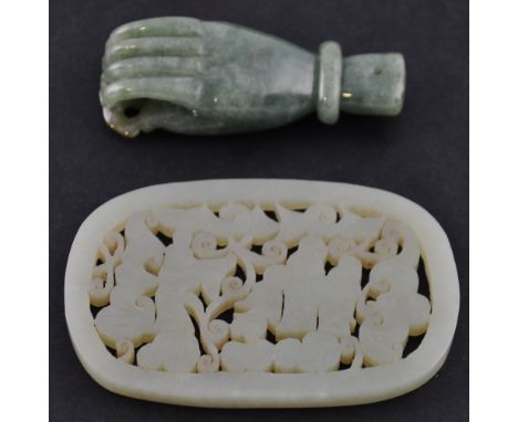 A Chinese jade pendant in the form of a hand together with a lighter jade perforated ornament depicting a figural scene