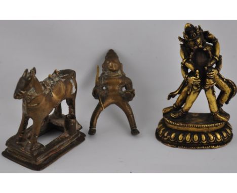 An early 20th Century Tibetan bronze of tantric deities, h:11cm, together with a similar bronze of an order on horseback 