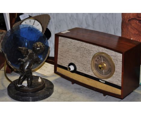 An early 20th Century bronzed metal and reconstituted marble table lamp modelled as a cherub together with a vintage radio an