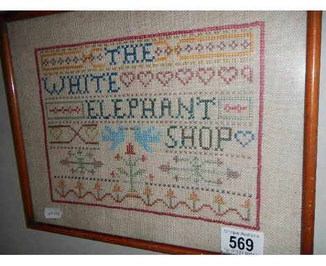 A framed and glazed cross stitch sampler.