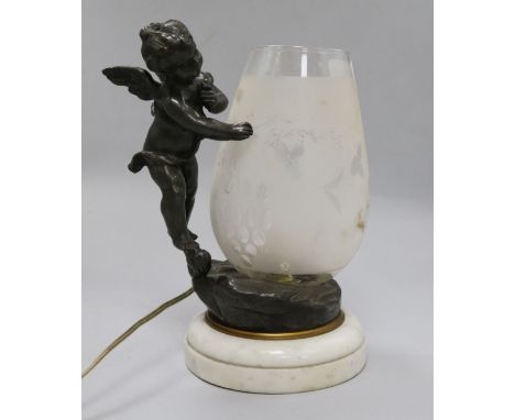 A cherub and glass table lamp