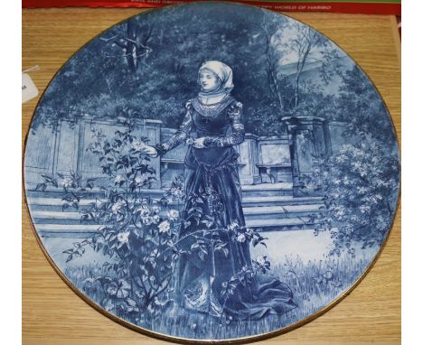 A blue-glazed circular ceramic wall plaque depicting a medieval lady in a garden, Dia 16in approx