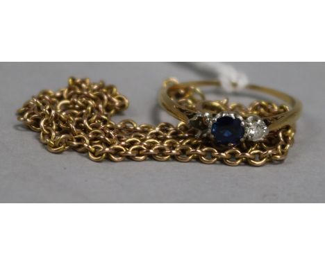 A three-stone sapphire and diamond ring, 18ct gold and platinum setting, and a 9ct gold fine chain, the ring with one small d