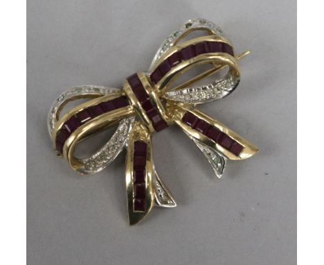 A 9ct gold ruby and diamond ribbon bow brooch, 26mm.