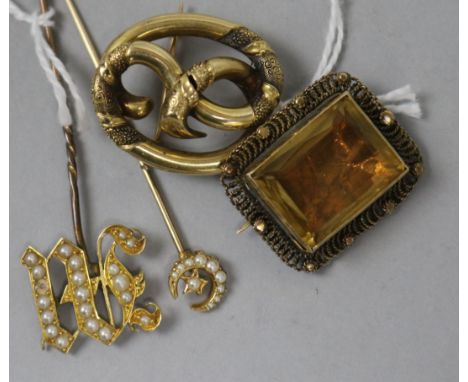 A Victorian yellow metal openwork brooch, a similar citrine brooch and two pearl set yellow metal stick pins.