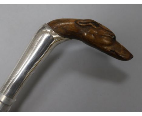 A white metal-mounted fruitwood walking stick with finely-carved whippet's head handle, L 3ft