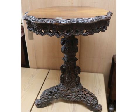 A carved hardwood tripod table, H.74cm