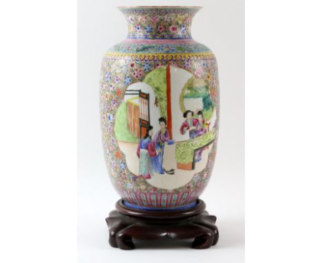 20th century Chinese famille rose porcelain vase with two panels of ladies at various pursuits, framed with extensive flower 