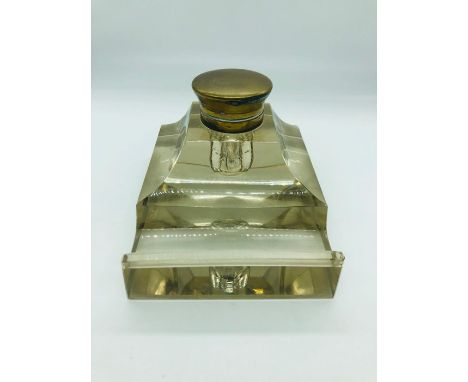 A glass inkwell with inset liner.
