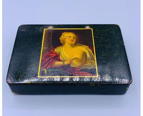 A snuff box with a painting of a classical lady.