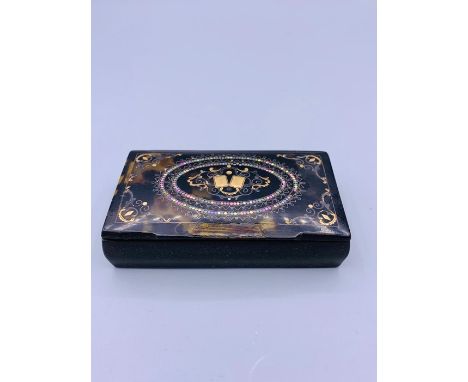 A Tortoiseshell snuff box with silver inlay.