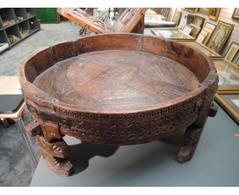 A traditional hand carved and wrought iron Indian Chakki table having good signs of age