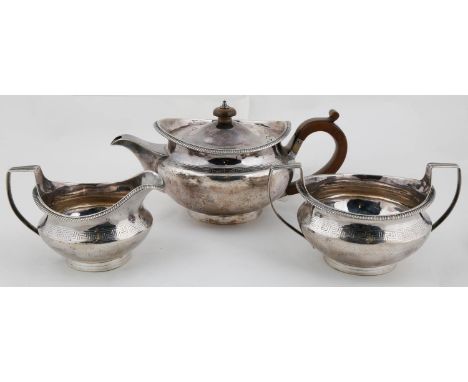 A GEORGE III SILVER TEA SERVICE, OF PROW FORM WITH GADROONED RIM AND GREEK KEY BORDER, THE DOMED LID WITH INTEGRAL HINGE, CRE