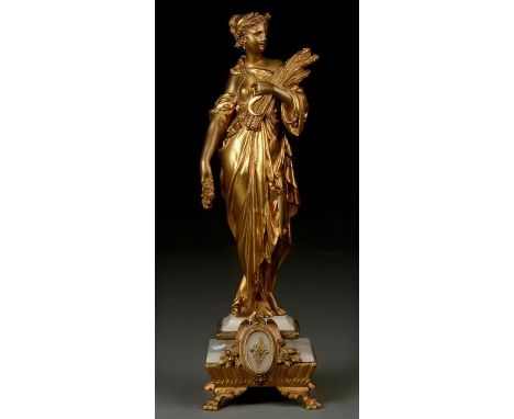 A 19TH C GILTMETAL FIGURE EMBLEMATIC OF SUMMER, HOLDING A SCYTHE CORN IN HER LEFT ARM, A GARLAND IN HER RIGHT HAND, STEPPED W