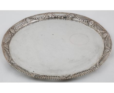 AN AUSTRO-HUNGARIAN SILVER SALVER, WITH PLAIN FIELD AND NEO CLASSICAL STYLE CAST OPENWORK BORDER OF PATERAE AND FESTOONS, IN 
