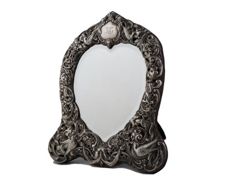 AN EDWARD VII SILVER DRESSING MIRROR, THE DIE STAMPED MOUNT WITH BIRDS, GROTESQUES AND OPEN TRELLIS SURROUNDING THE HEART SHA